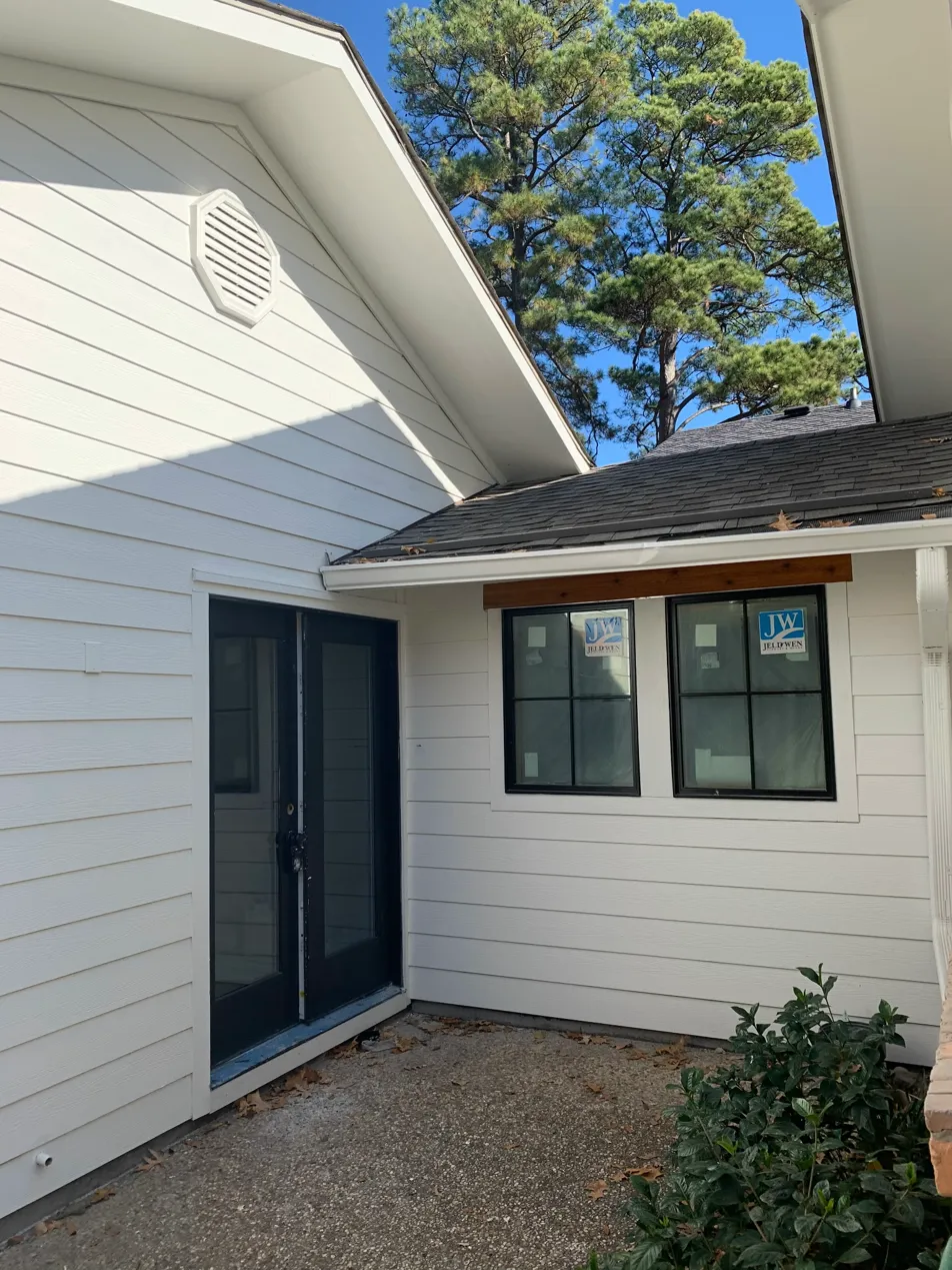 White siding and dark door exterior painting completed in Shreveport