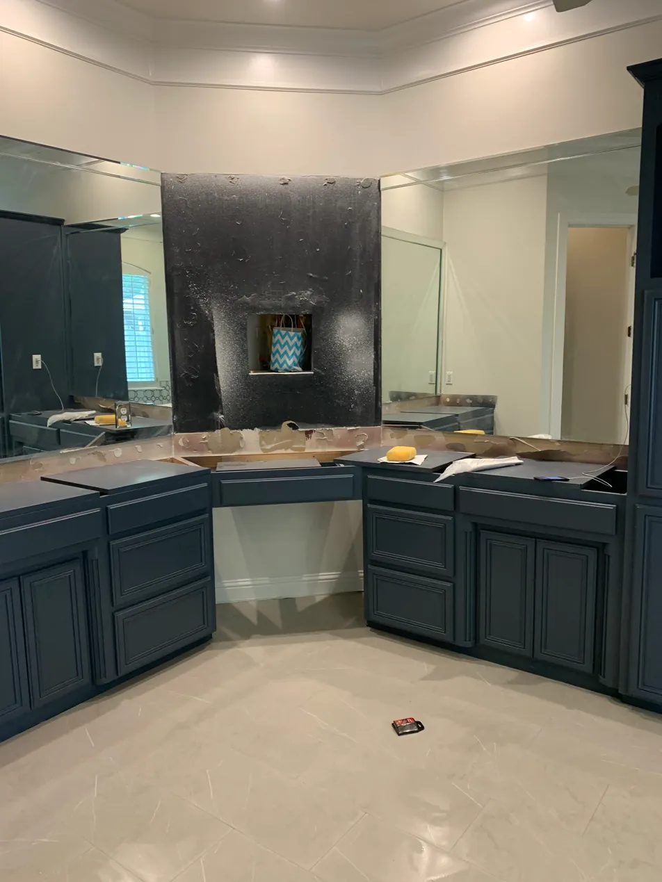 Bathroom vanity refinished in dark navy after cabinet painting