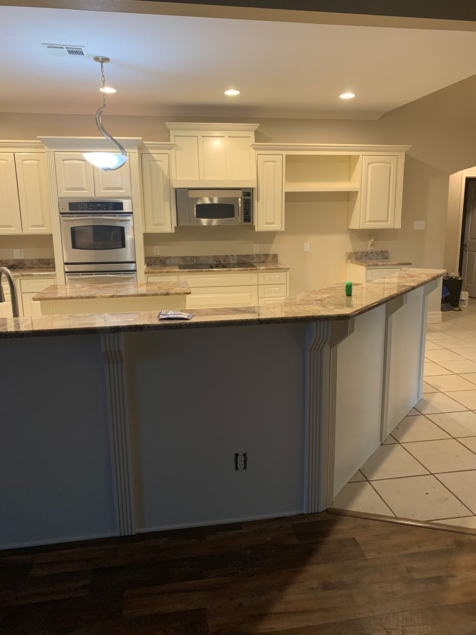 Interior kitchen painting — white cabinet finish completed