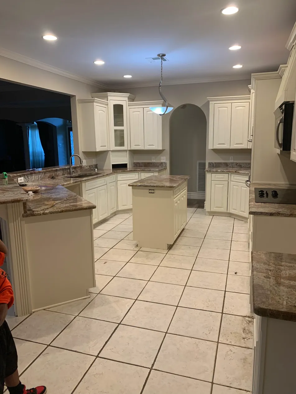 Finished kitchen cabinet painting with island and cream cabinets