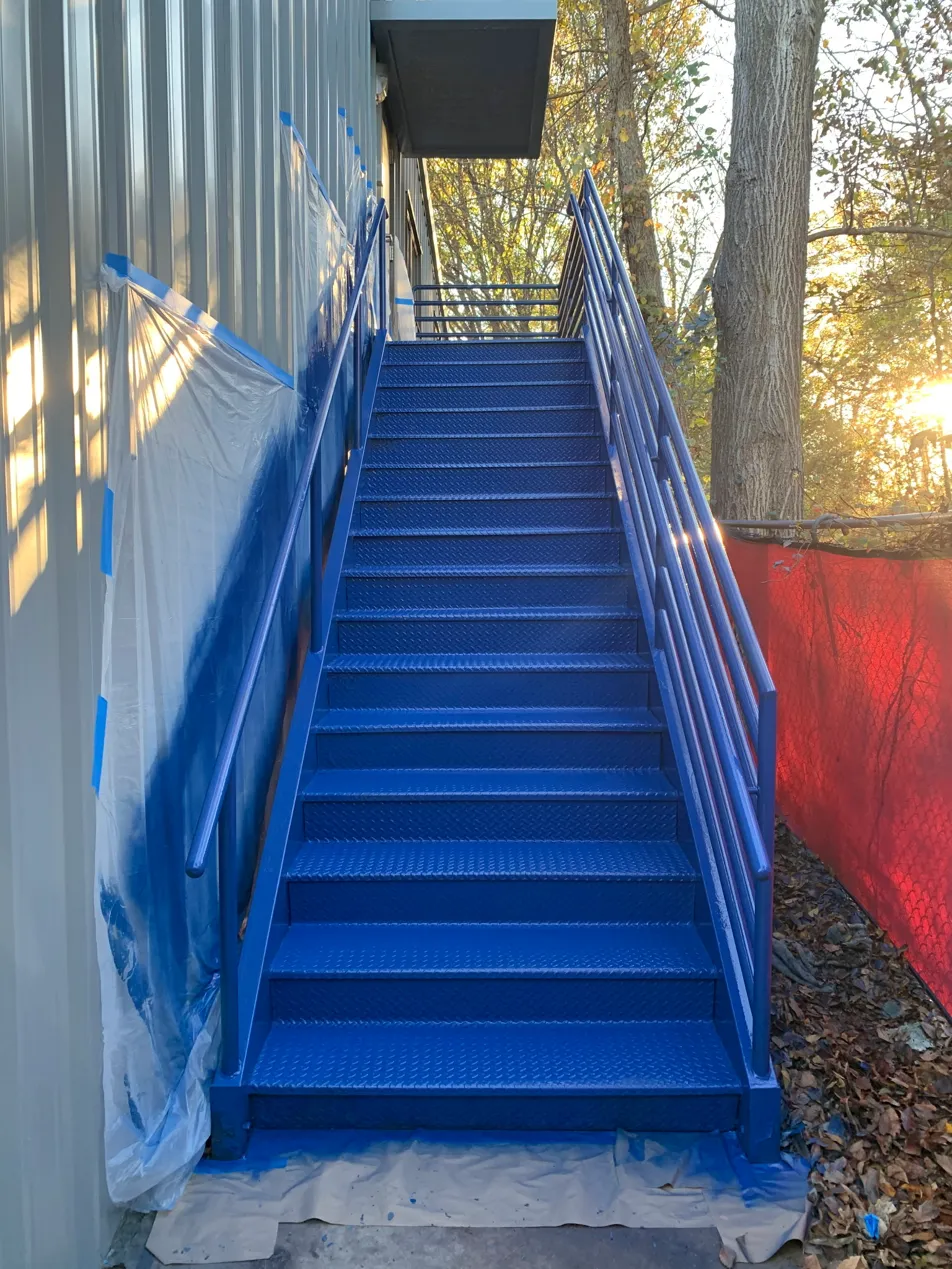 Commercial metal staircase refinished in a bold blue coating